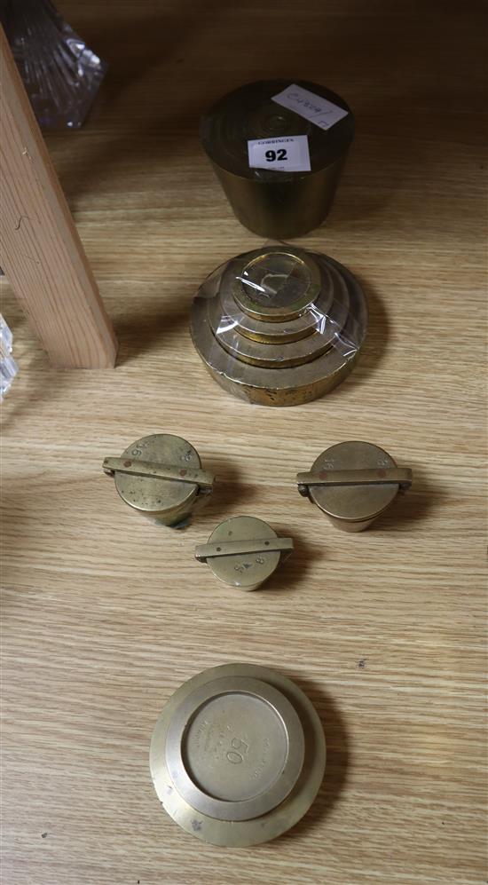 Five sets of flat brass weights and two others